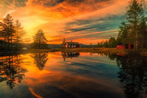 Sunset Over House On The Lake By Ole Henrik Skjelstad