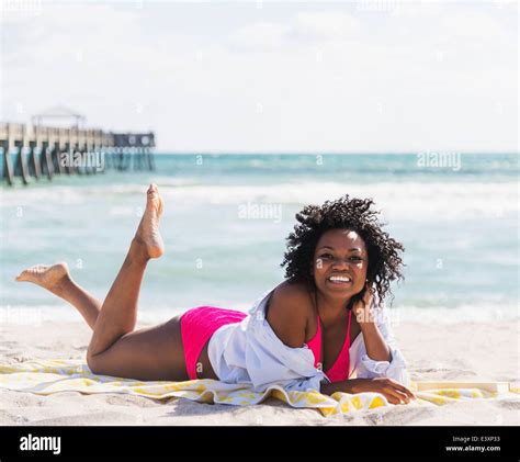 African American Woman Relaxing On Beach Stock Photo Alamy