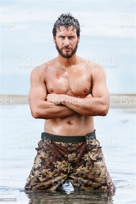 Confident Gorgeous Athletic Army Posing At The Sea Stock Photo