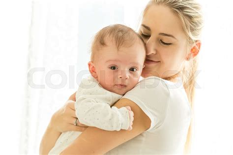 Closeup Portrait Of Beautiful Young Mother Cuddling Her 3 Months Old