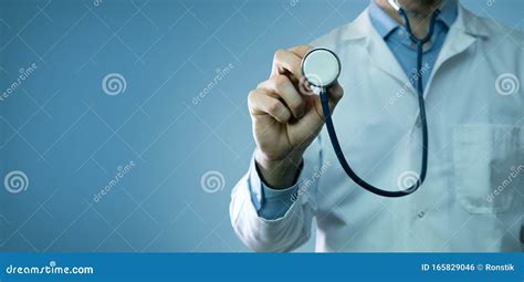 Healthcare And Medicine Doctor In White Coat Holding Stethoscope On Blue Background Stock