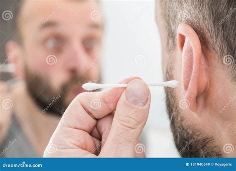 Man Removing Wax From Ear Using Q Tip Stock Image Image Of Scared