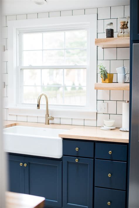 Many cabinet manufacturers can make them the could you use upper cabinets as lower cabinets? Deep blue kitchen cabinets, brushed brass hardware, white square subway tile, light butcher ...