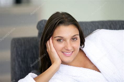 Young Woman Wearing Bathrobe Lying On The Couch Stock Photo By