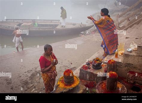 pilgrims making a ritual offering and praying ghats of ganges river varanasi uttar pradesh