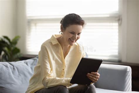 Happy Cheerful Mature Lady Using Online App On Tablet Computer Stock Image Image Of Female