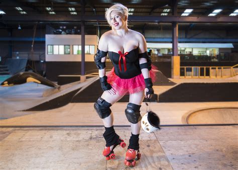 A Woman Wearing Roller Skates Is Posing For The Camera