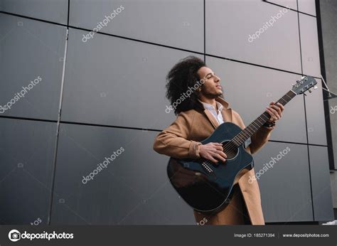 African American Street Musician Playing Guitar Outdoors ⬇ Stock Photo