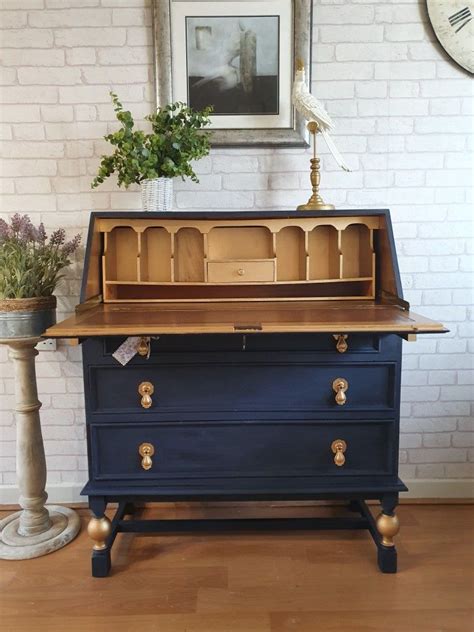 Paint gives a piece of furniture a whole new look! Every one needs a Navy and Gold Bureau in their life ...