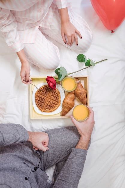 free photo couple eating romantic breakfast on white bed