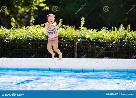 Little Girl Jumping Into Swimming Pool Stock Photo Image Of
