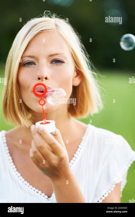 Look At All The Bubbles Cute Young Woman Blowing Soap Bubbles Outdoors
