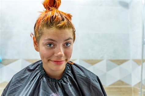 Premium Photo A Teenage Girl Dyes Her Hair Red The Process Of Dyeing