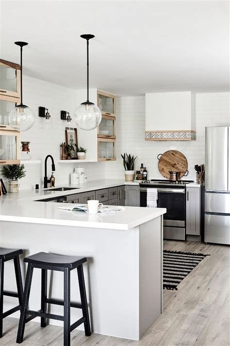 Many of the latest small kitchen designs have open shelving in place. This Chic One-Bedroom Condo Looks Way Bigger Than 750 Square Feet | Condo kitchen, Modern ...