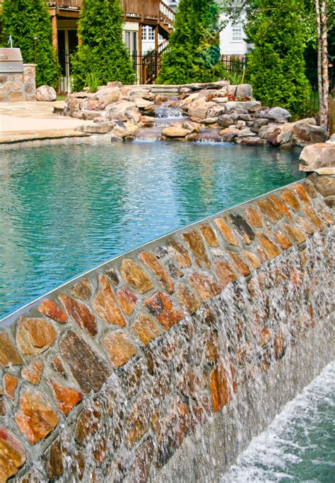 South American Style Pool Designed With Rock Wall Spillway By Shane