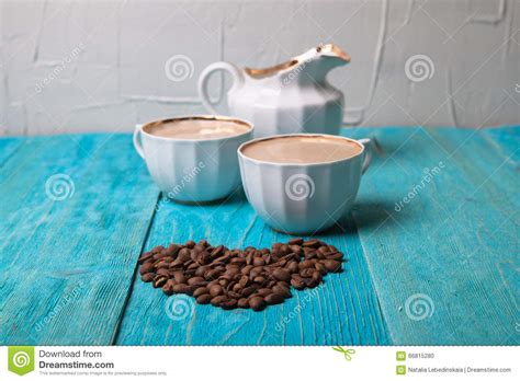 Coffee With Milk Pour Milk From The Milkman Blue Wooden Background