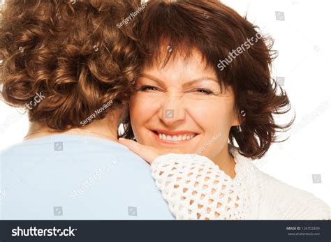 Happy Smiling And Wincing Senior Woman Hugging His Husband Stock Photo