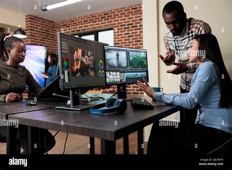 Footage Editing Specialist Using Multi Monitor Workstation To Improve