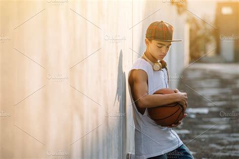 Young Man Holding A Basketball Ball ~ Sports Photos ~ Creative Market