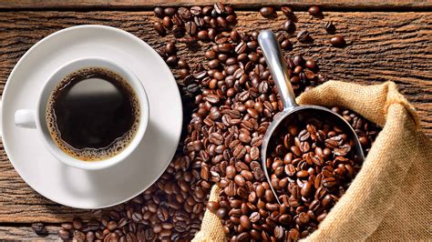 Cup Of Coffee And Roasted Beans On Wood Table Uhd 4k Coffee Wallpaper