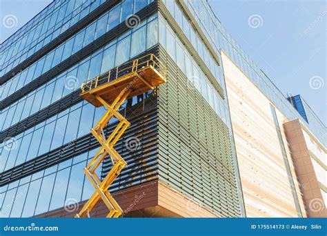 Builders On The Air Platform During Installation Of Facade Glazing The