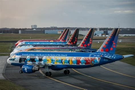 A Row Of Colorfully Painted Airplanes On An Airport Runway