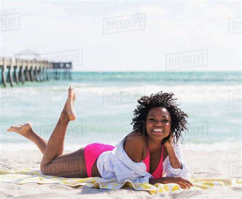 African American Woman Relaxing On Beach Stock Photo Dissolve