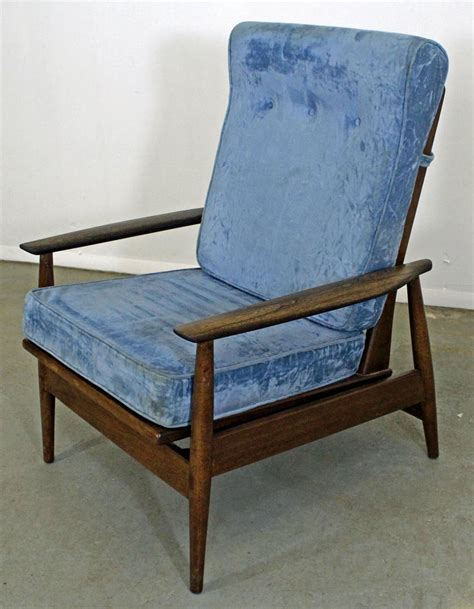 Featuring a cane inset back and an upholstered seat, this lounge chair provides exceptional comfort. Mid-Century Danish Modern High Back Rocker Walnut Lounge Chair at 1stdibs