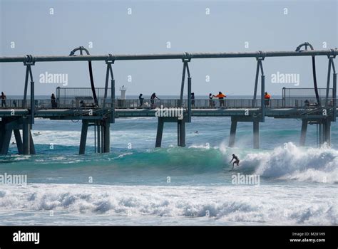 Surfing And Fishing At The Spit On The Gold Coast In Australia Stock