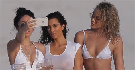 8 pictures of kim kardashian shows off impressive assets in wet shirt and thong