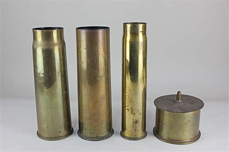 Three First World War Brass Shell Casings And A Trench Art Shell