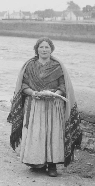 An Old Photo Of A Woman Standing By The Water