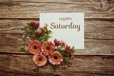 Happy Saturday Typography Text With Flowers On Wooden Background Stock