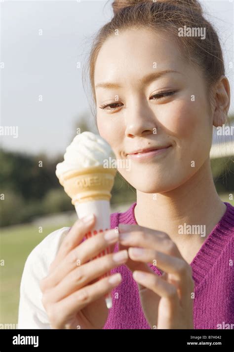 A Woman Eating Ice Cream Cone Stock Photo Alamy