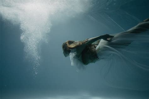 Woman In Bridal Dress Swims And Dives Underwater Stock Photo Download