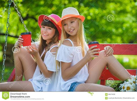 Joyful Girlfriends Having Fun On Swing Outdoor Friendship Concept