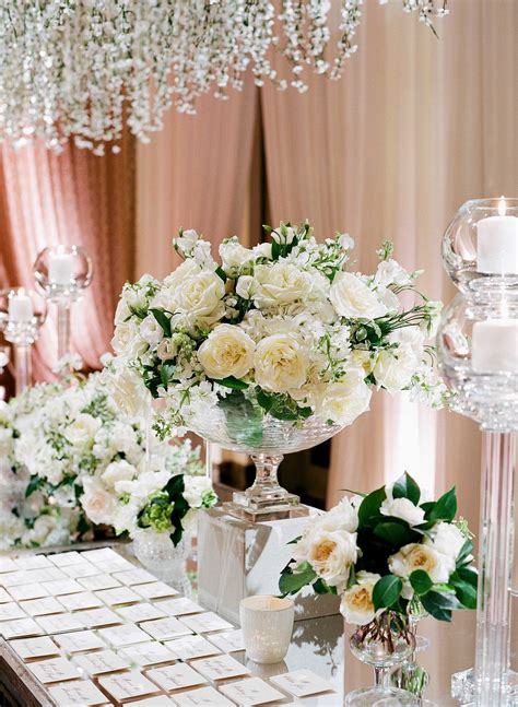 Escort cards direct guests to their reception tables and can be showcased simply on a table or with an elaborate display. Ivory & Greenery Escort Card Table Décor