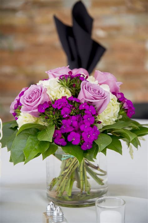 Maybe you would like to learn more about one of these? Simple and sweet centerpieces, mix of purple flowers. Made ...