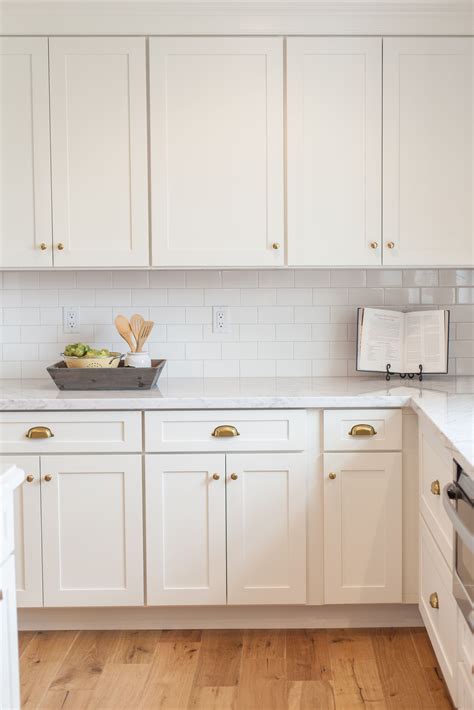 White Shaker Cabinetry With Brass Cups And Knobs By Rafterhouse