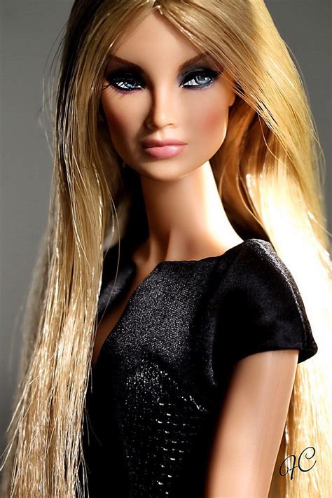 A Close Up Of A Barbie Doll With Long Blonde Hair And Blue Eyeliners