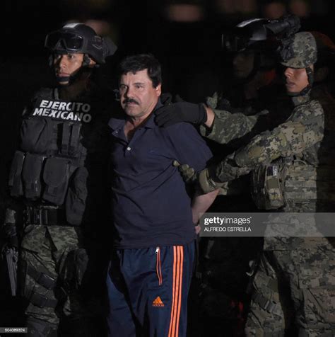 Drug Kingpin Joaquin El Chapo Guzman Is Escorted To A Helicopter At