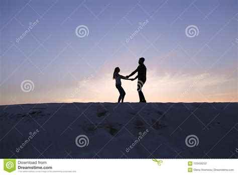 Lovers Run Towards Each Other And Swirl On Sandy Hill In Desert Stock