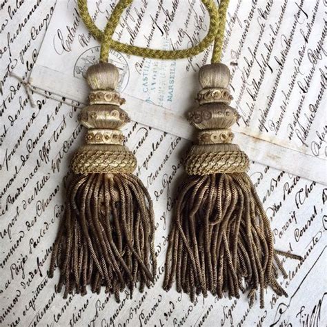 Two Tassels Are Sitting On Top Of A Piece Of Paper