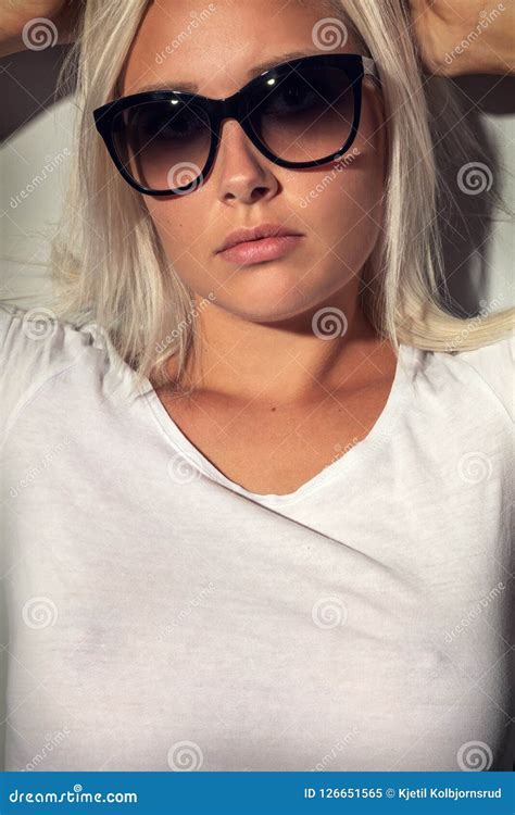 Gorgeous Blonde Woman With Sunglasses In Warm Colored Light Stock Image