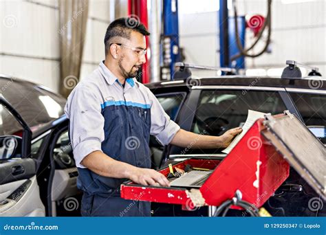 Handsome Mechanic Job In Uniform Working On Car Stock Image Image Of