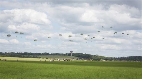 Allied Troops Performing A Commemorative D Day Parachute Decent Onto