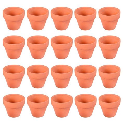 Twelve Orange Plastic Cups Are Lined Up In The Shape Of Flowerpots