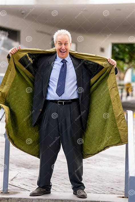 Businessman Flashing Open His Trenchcoat To Show His Suit Stock Photo
