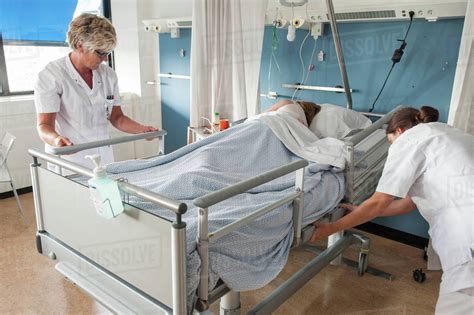 Nurses Adjusting Patients Hospital Bed Stock Photo Dissolve