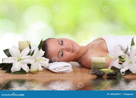 Woman Lying Down Relaxing On A Massage Bed At Spa Stock Image Image Of Flower Lily 189569691